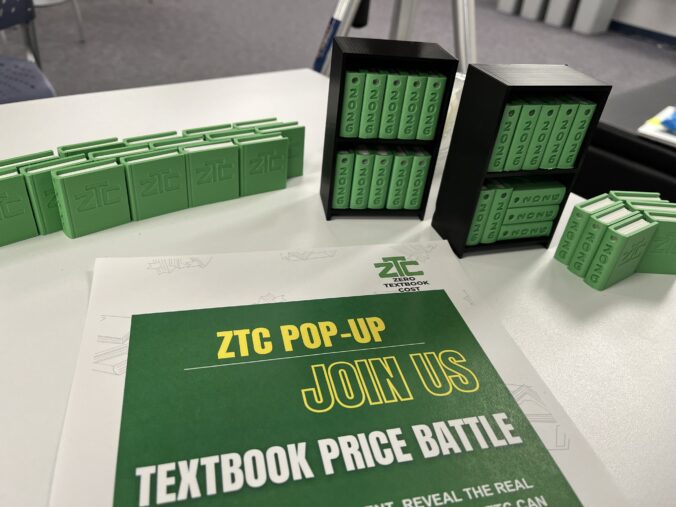 ZTC pop-up tabling featuring a ZTC promotional poster and multiple 3D-printed books.